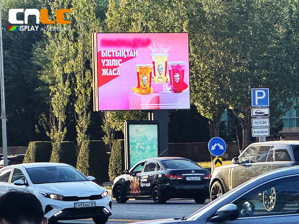 Digital out-of-home (DOOH) LED billboard installed on busy street corner